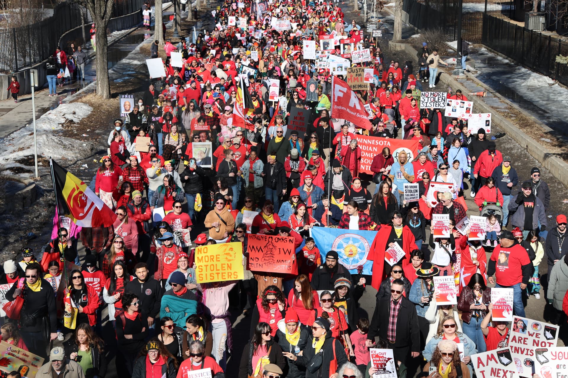 Hundreds of marchers walk in the streets during Minneapolis' MMIR Day of Remembrance activities.