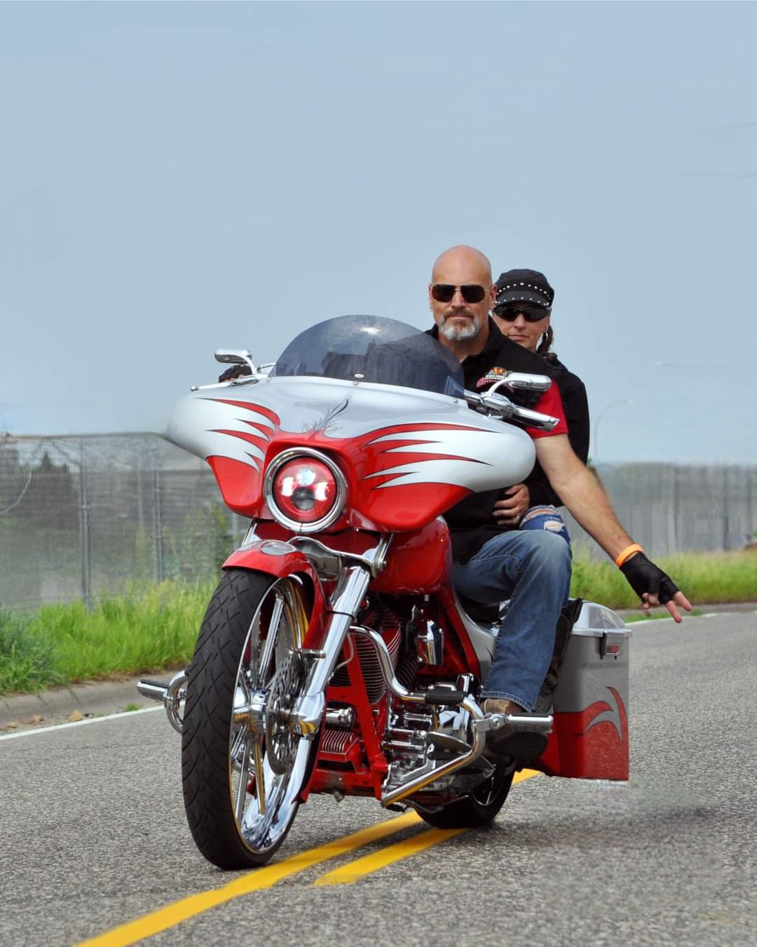 Don Moehrle riding motorcycle with passenger