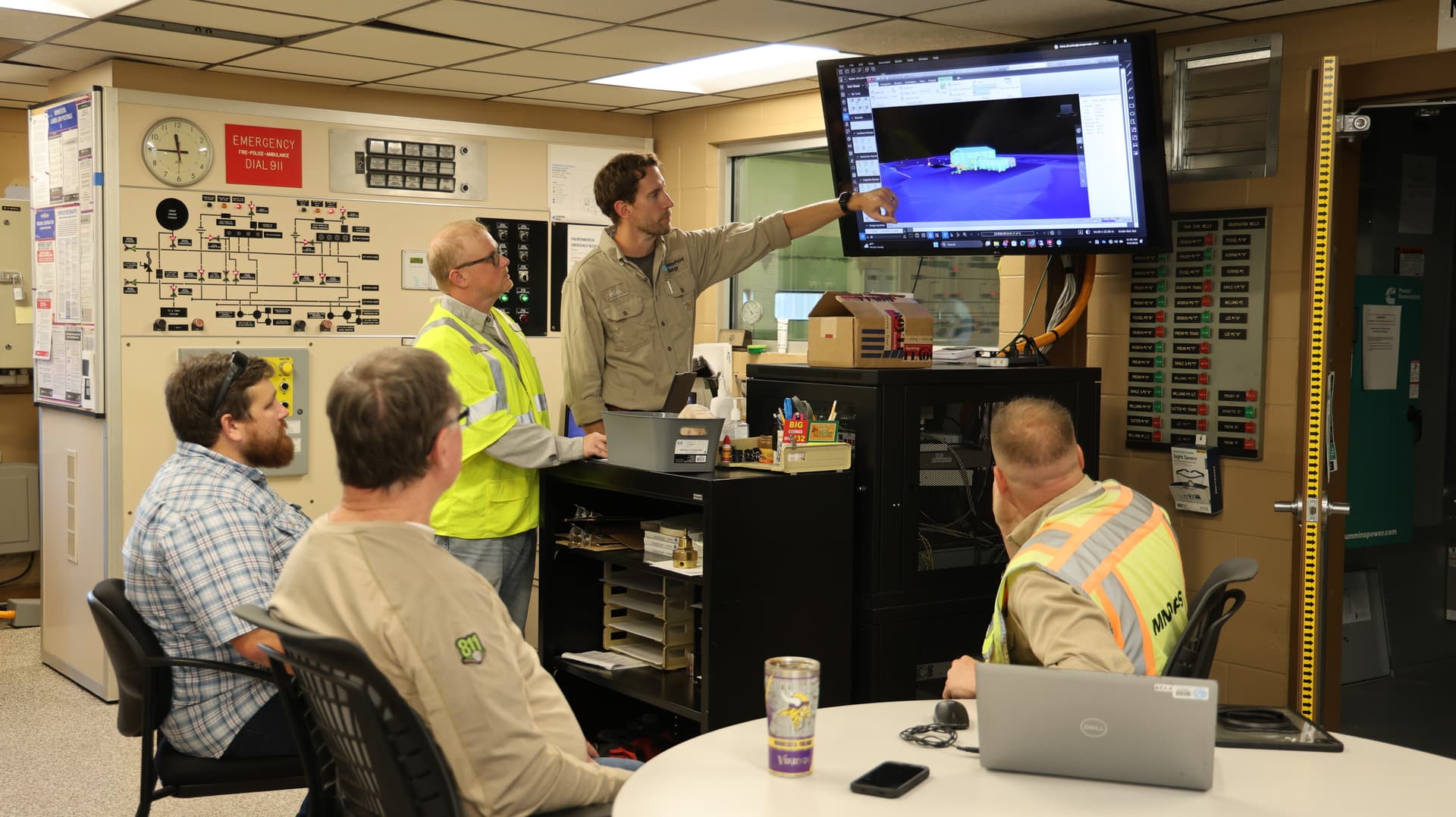 A group of staff from pipeline safety examining a screen