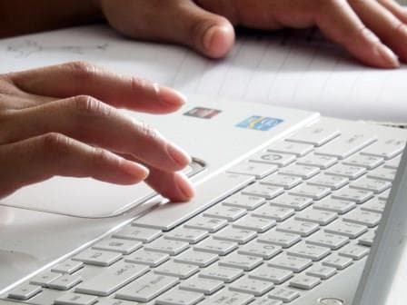 Image of finger pressing computer keyboard