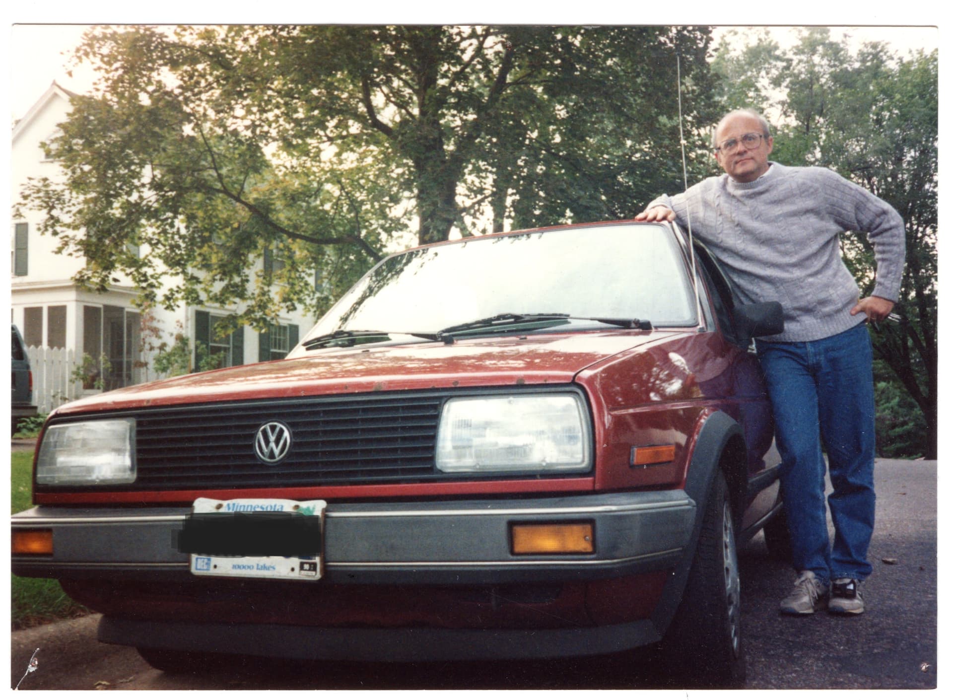Henry Owen leans against his VW Jetta 5-speed car.