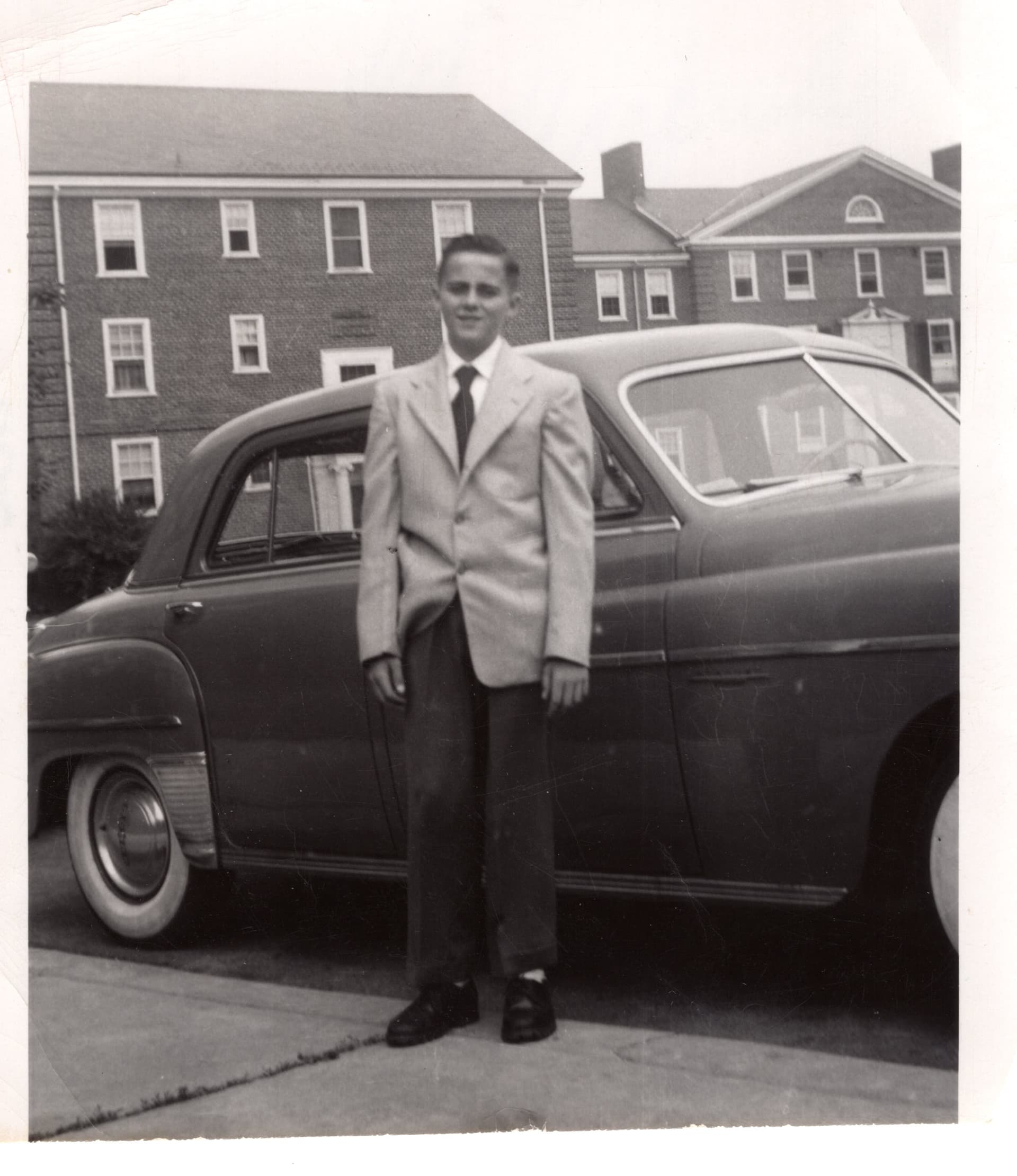 Henry Owen stands near a 1949 Dodge car when he was 15 years old.