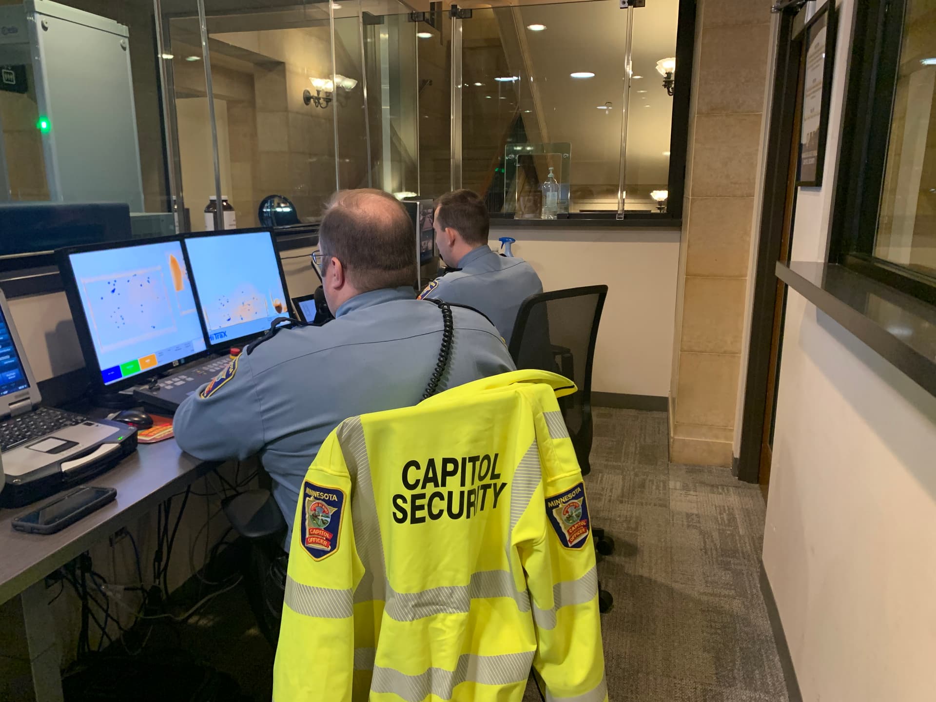 Capitol Security Officer sitting with back to camera looking at monitors